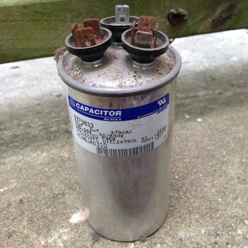 A critical component of air conditioners is the capacitor, which commonly fails. The convex top indicates failure.