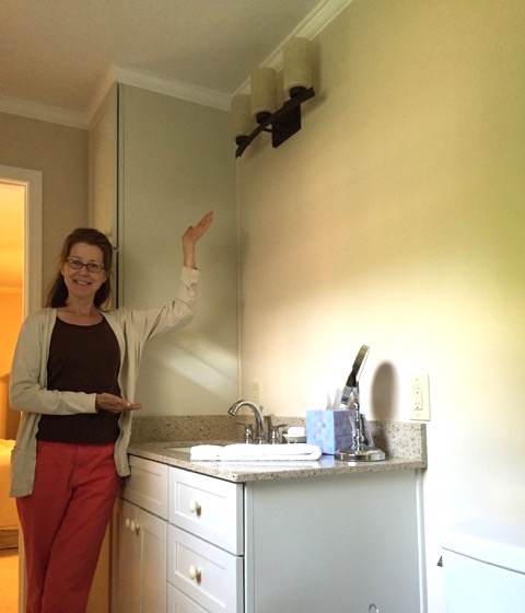 Elaine showing off the new bathroom light fixture
