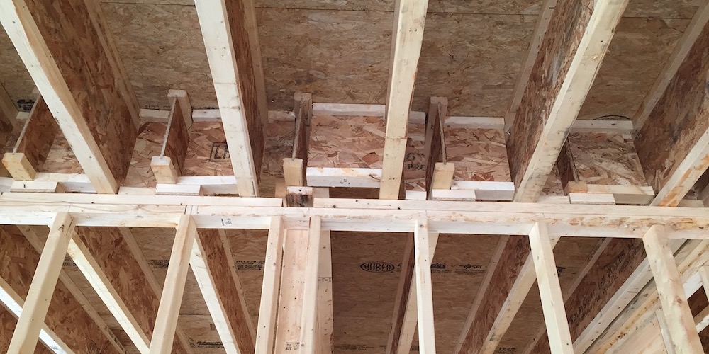 A really bad job of blocking the joist cavities in a wall separating the garage from the living space