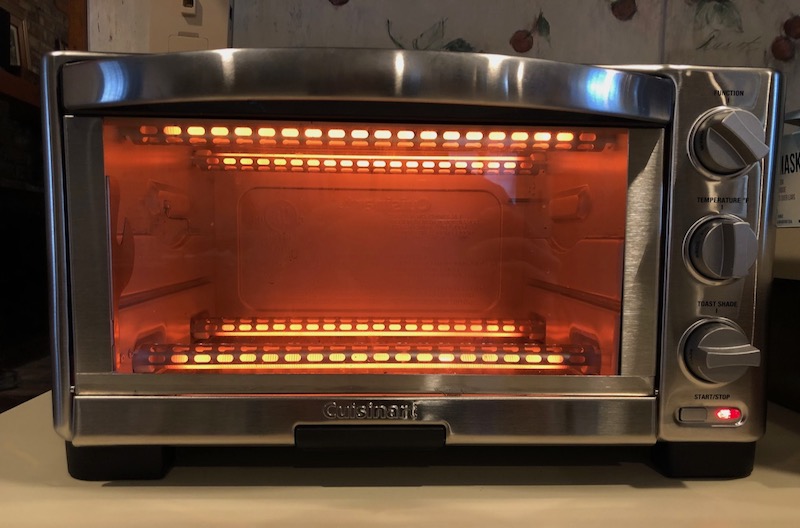 A toaster oven uses electric resistance heat and is 100% efficient