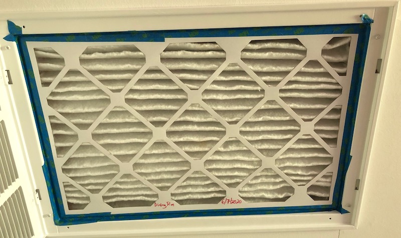 Clean MERV-13 filter in dining room, taped into filter grille
