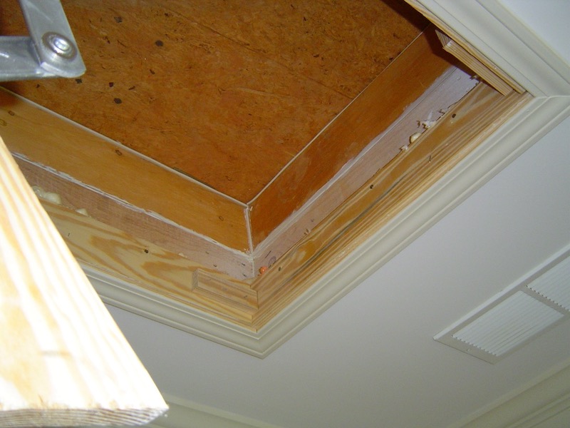 Attic access air-sealed with a site-built wood cover