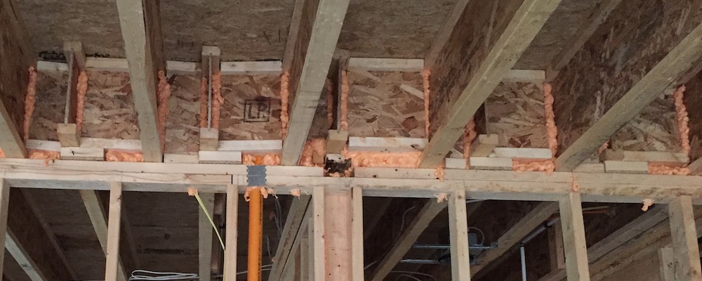 Garage wall with ugly blocking and what is most likely a leaky attempt at air sealing