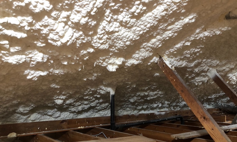 Spray foam insulation installed with enough depth to cover the rafters completely