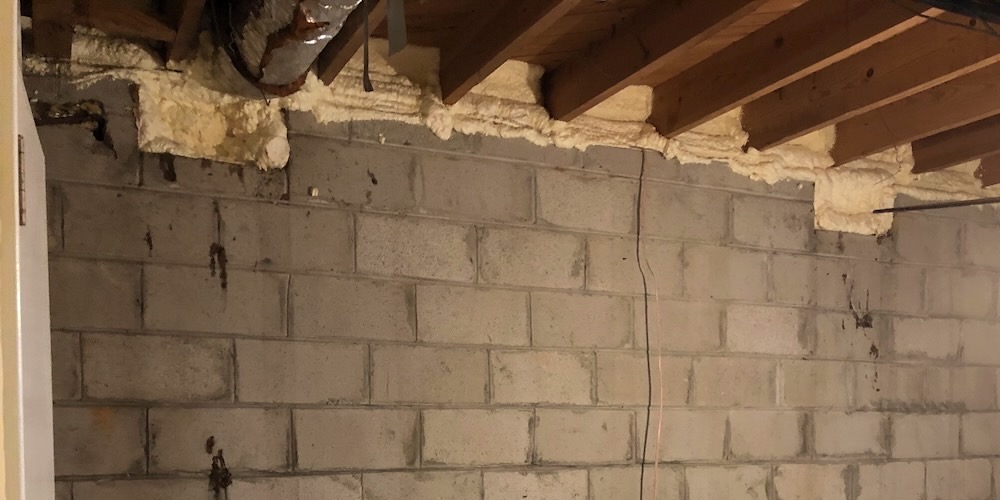 Crawl space vents hidden from view in a finished basement bedroom. They're now sealed with spray foam.