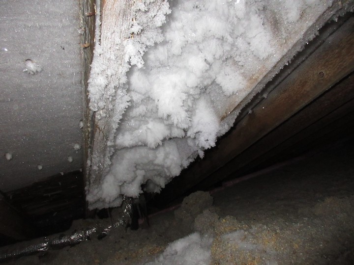 A frosty attic rafter bay above a bathroom exhaust fan [Courtesy of Grant Walkin]