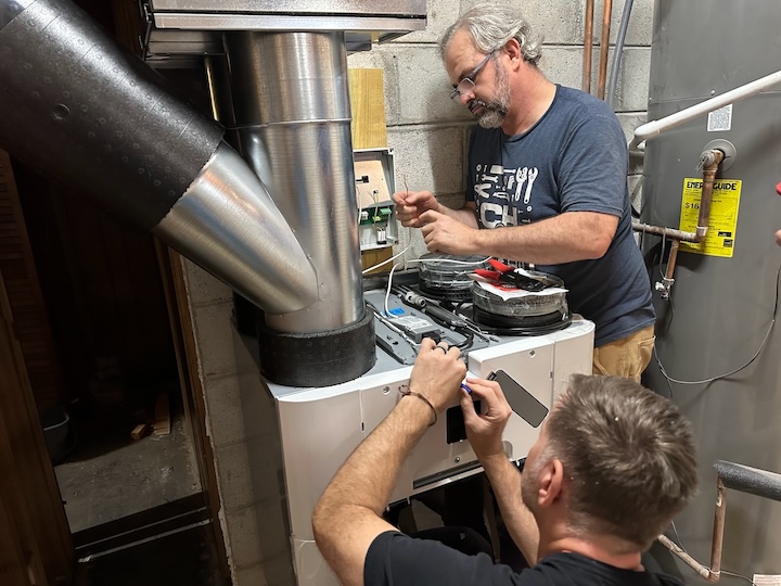 Aubrey and Chris wiring the ERV at the end of the second day